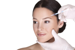 Woman gazes to the side, gently smiling during a Botox injection