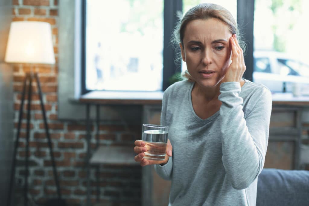Woman going through perimenopause drinking water